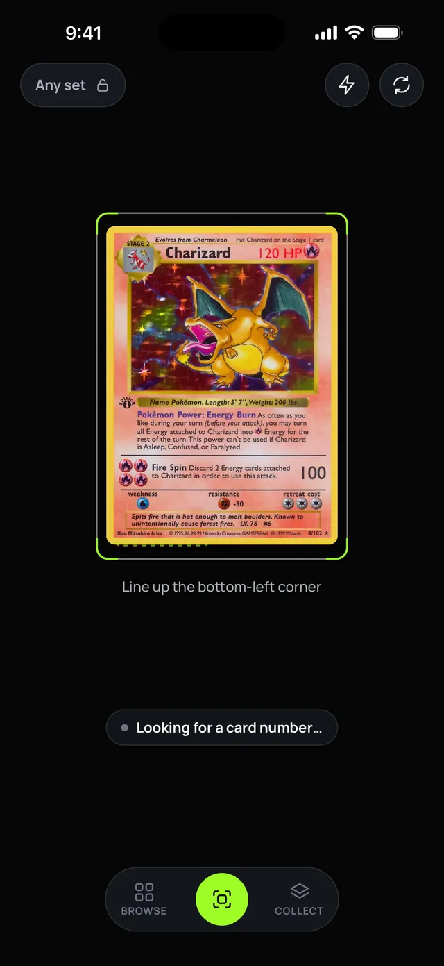 The Scan screen: an 'Any set' lock chip at the top, a Base Set Charizard held inside a card-shaped guide with lime corner brackets, 'Line up the bottom-left corner' under the guide, and 'Looking for a card number' beneath.